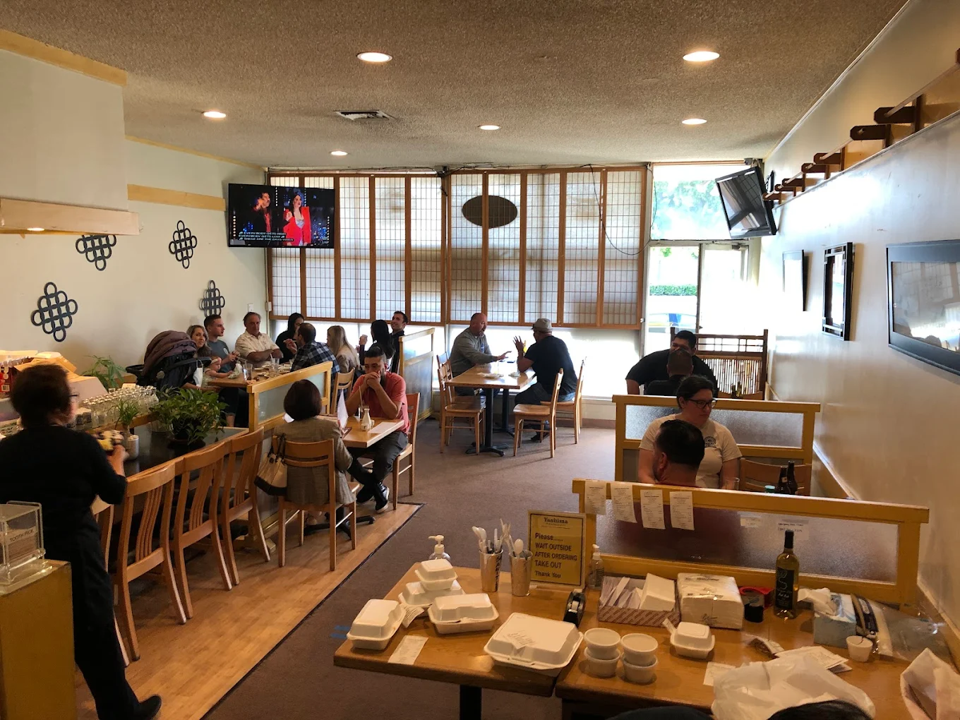 A happy family enjoying a meal together at a restaurant. | family restaurant Covina