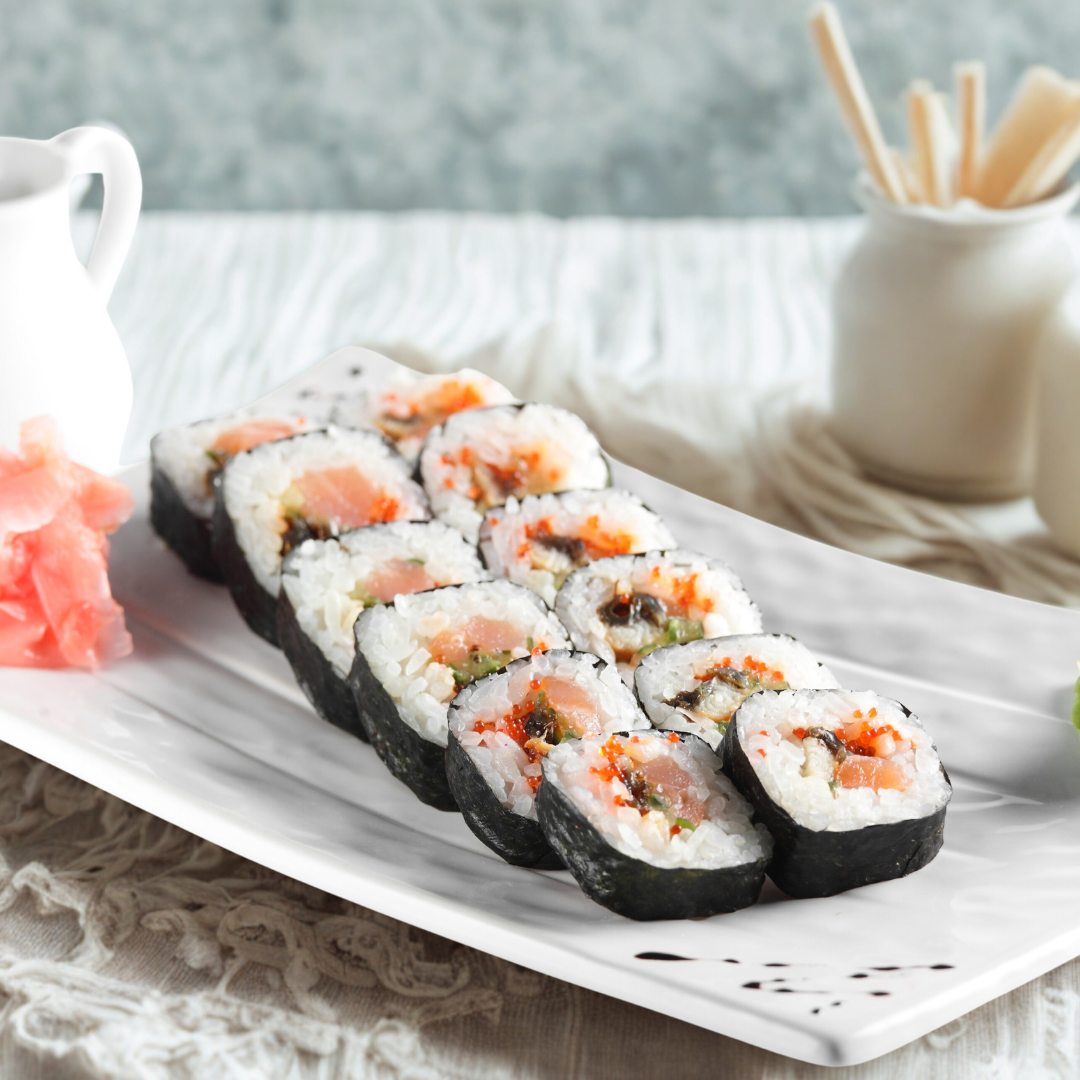A colorful assortment of sushi rolls, showing the variety on a party platter.